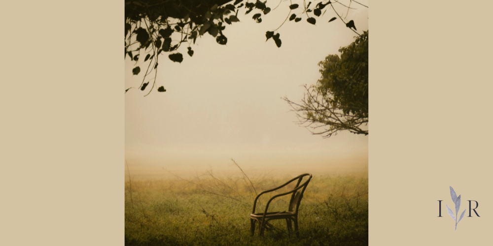 empty chair in quiet field representing sitting in silence and calm moments